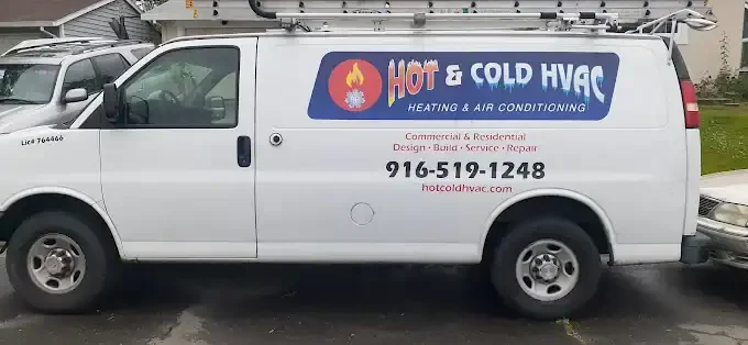 White service van with blue and red HVAC company wrap, flame logo, and contact details